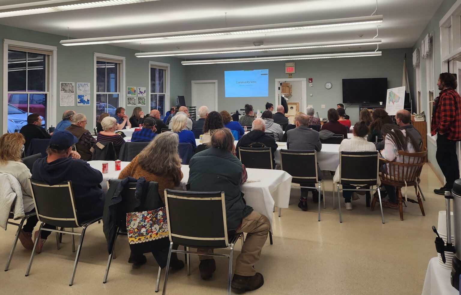 Attendees of Clarksburg community workshop; room full of people watching presentation with workshop instructions